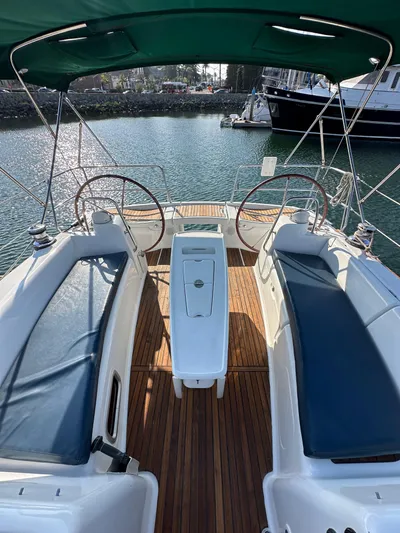 Shamrock Yacht Photos Pics 2011 Beneteau Oceanis 40 sailboat cockpit with dual steering wheels and teak flooring.