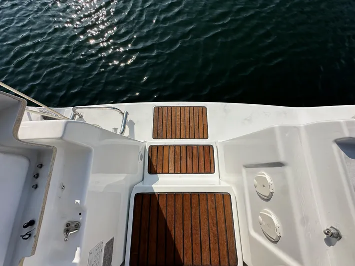 Shamrock Yacht Photos Pics Teak deck of 2011 Beneteau Oceanis 40 sailboat with water view.
