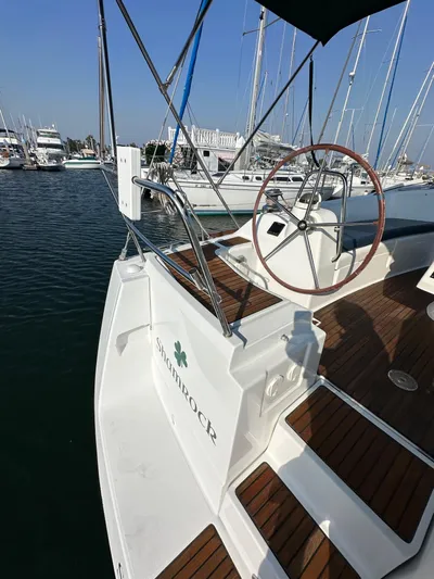 Shamrock Yacht Photos Pics 2011 Beneteau Oceanis 40 sailboat with wooden deck, docked in marina.