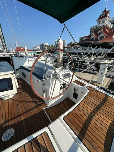 Shamrock Yacht Photos Pics Beneteau Oceanis 40 sailboat, 2011 model, docked with wooden deck and steering wheel visible.