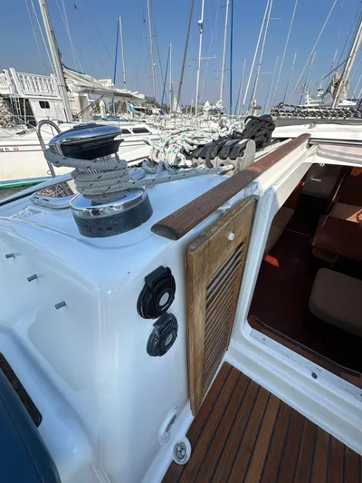 Shamrock Yacht Photos Pics Beneteau Oceanis 40 sailboat deck, 2011 model, with winch and ropes in a marina setting.