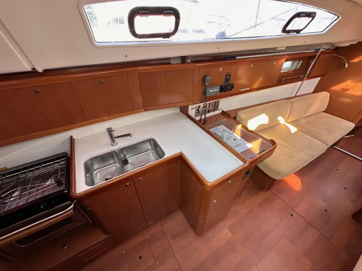 Shamrock Yacht Photos Pics Interior of 2011 Beneteau Oceanis 40 yacht, featuring kitchen and seating area.