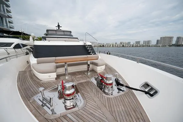 Ryen - Sl106/637 Yacht Photos Pics Sanlorenzo SL106 2017 yacht deck with seating and winches, docked by waterfront buildings.
