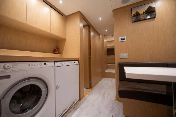 Ryen - Sl106/637 Yacht Photos Pics Laundry area in 2017 Sanlorenzo SL106 yacht with modern appliances and wood cabinetry.