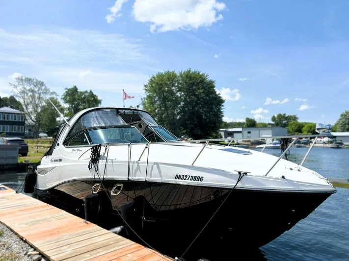  Yacht Photos Pics 2012 Rinker 310 Fiesta Vee boat docked on a sunny day by the water.