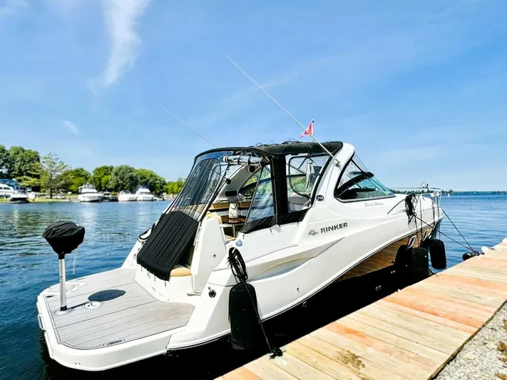  Yacht Photos Pics 2012 Rinker 310 Fiesta Vee boat docked on a sunny day.