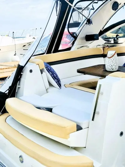  Yacht Photos Pics 2012 Rinker 310 Fiesta Vee boat interior with beige seating and decorative pillow.