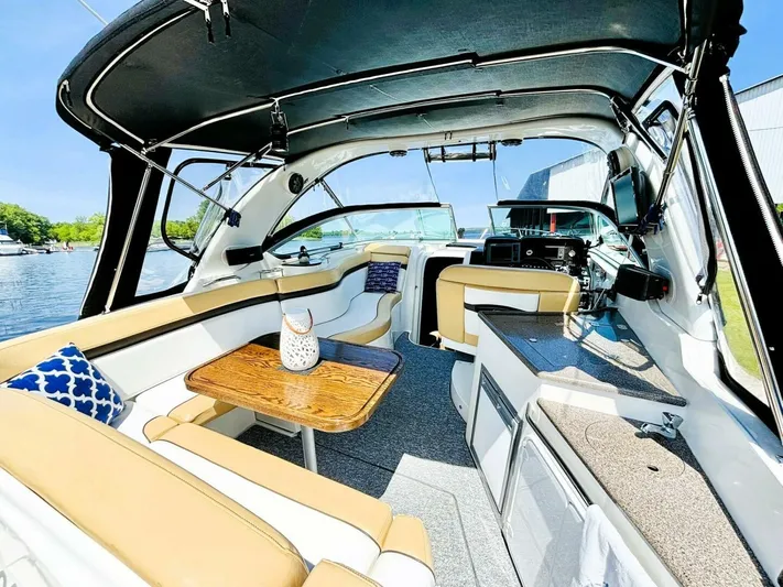  Yacht Photos Pics 2012 Rinker 310 Fiesta Vee boat interior with seating, table, and helm.