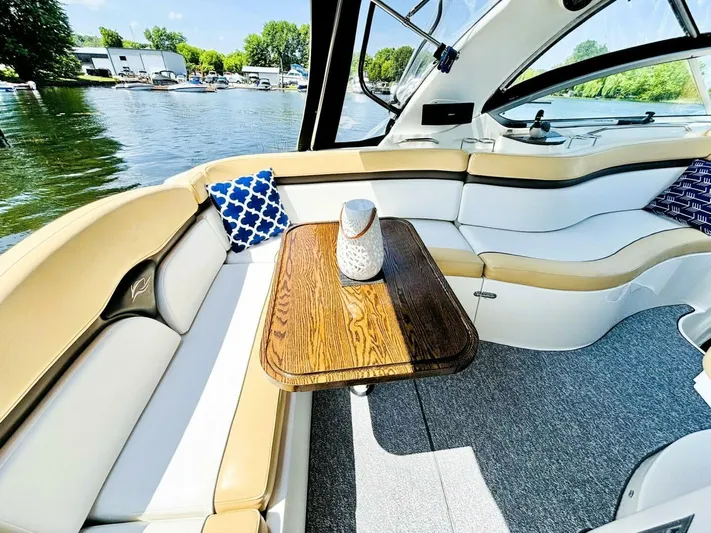  Yacht Photos Pics Luxurious 2012 Rinker 310 Fiesta Vee boat interior with elegant seating and wooden table.