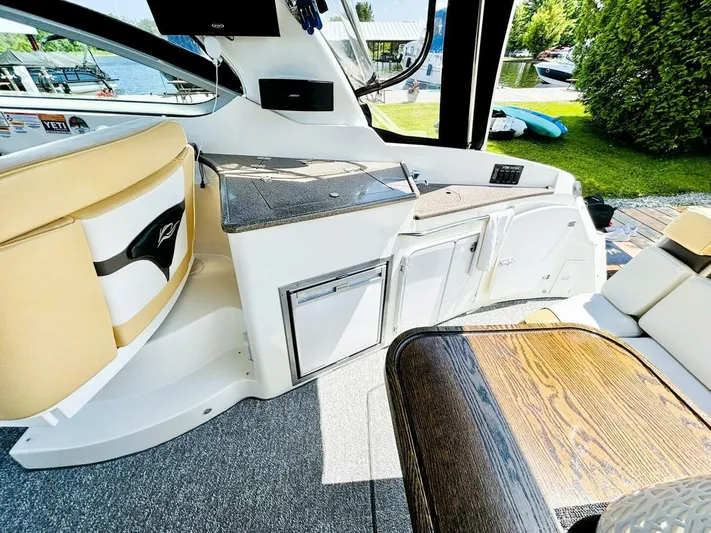  Yacht Photos Pics Interior of 2012 Rinker 310 Fiesta Vee boat with seating and kitchenette.