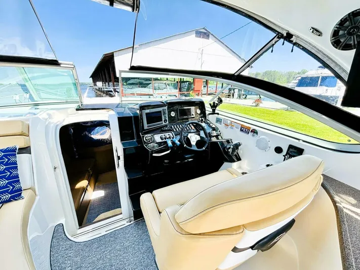  Yacht Photos Pics 2012 Rinker 310 Fiesta Vee boat cockpit with modern controls and comfortable seating.