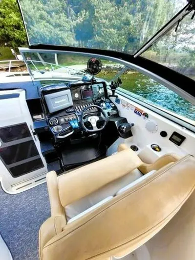  Yacht Photos Pics Interior cockpit of 2012 Rinker 310 Fiesta Vee boat with steering wheel and controls.