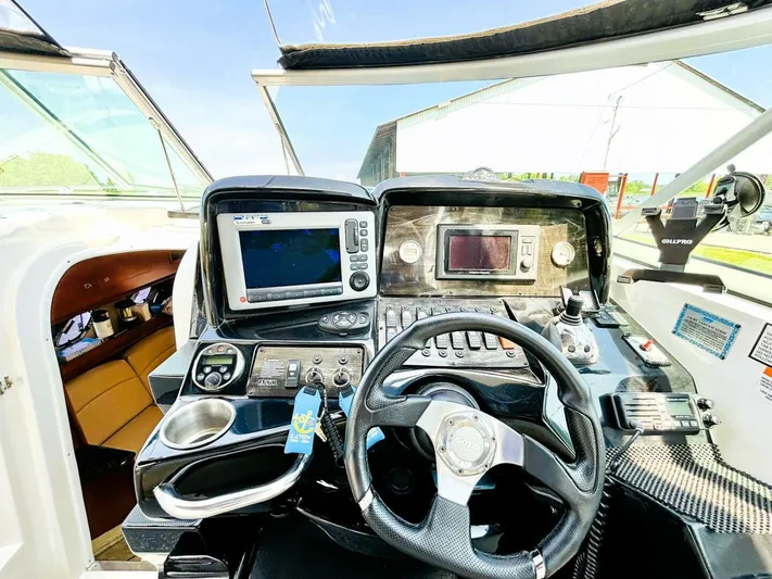  Yacht Photos Pics 2012 Rinker 310 Fiesta Vee boat dashboard with navigation controls and steering wheel.