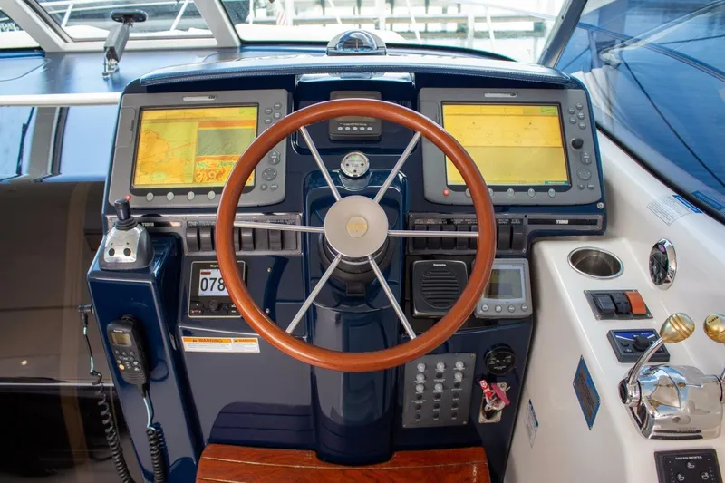  Yacht Photos Pics Helm of 2007 Tiara 3900 Sovran yacht with dual navigation screens and wooden steering wheel.