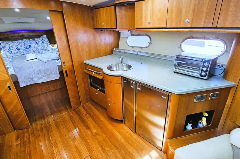  Yacht Photos Pics 2007 Tiara Yachts 3900 Sovran interior with kitchenette and cozy sleeping area.