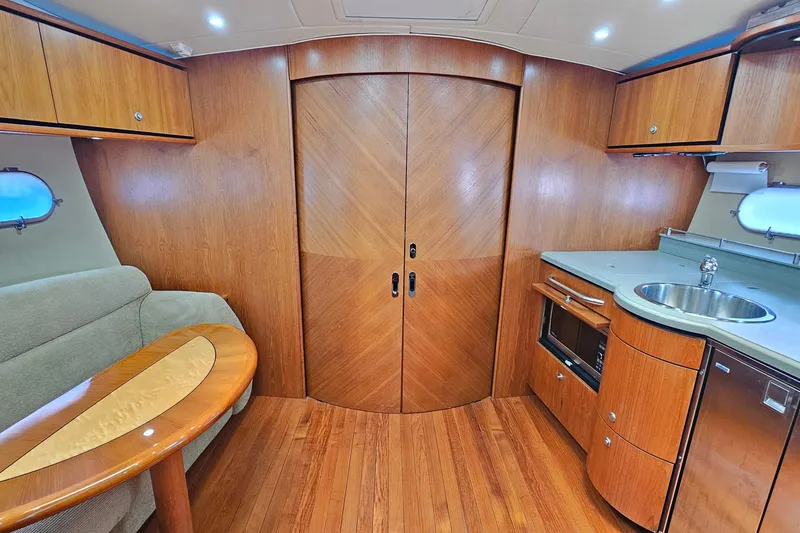  Yacht Photos Pics 2007 Tiara Yachts 3900 Sovran interior with wood finish, kitchenette, and seating area.