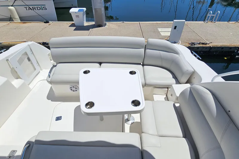  Yacht Photos Pics 2007 Tiara Yachts 3900 Sovran cockpit with white seating and table, docked by water.