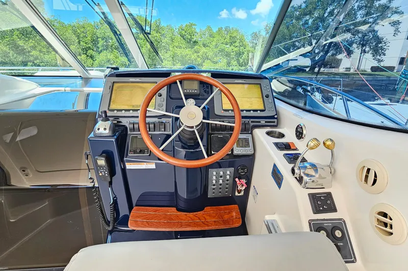  Yacht Photos Pics 2007 Tiara Yachts 3900 Sovran helm with wooden steering wheel and navigation controls.