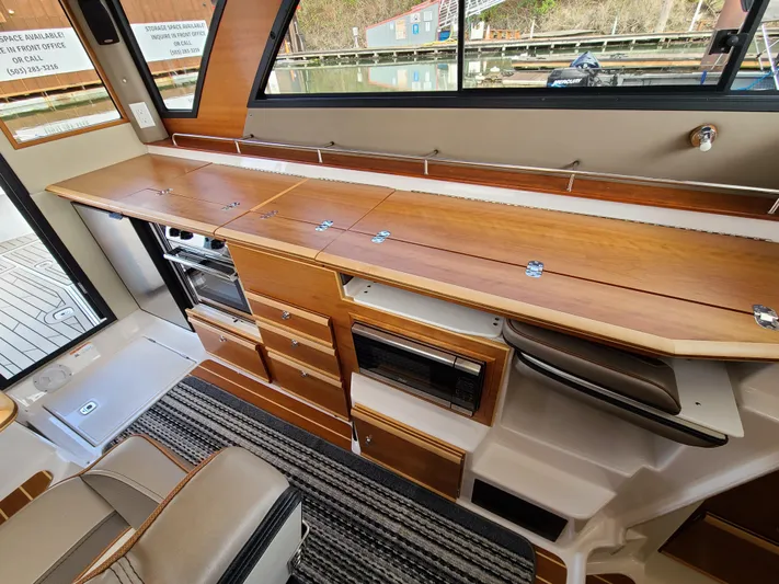  Yacht Photos Pics 2023 Cutwater C-30 Sedan NW Edition interior with sleek wooden cabinetry and modern appliances.