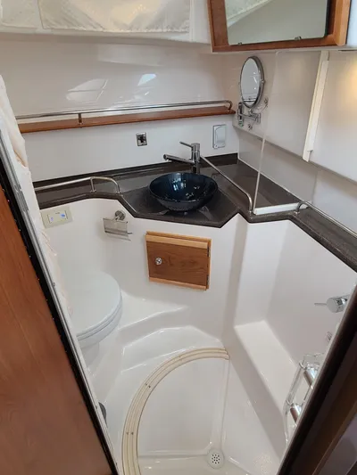  Yacht Photos Pics 2023 Cutwater C-30 Sedan NW Edition bathroom with modern fixtures and compact design.