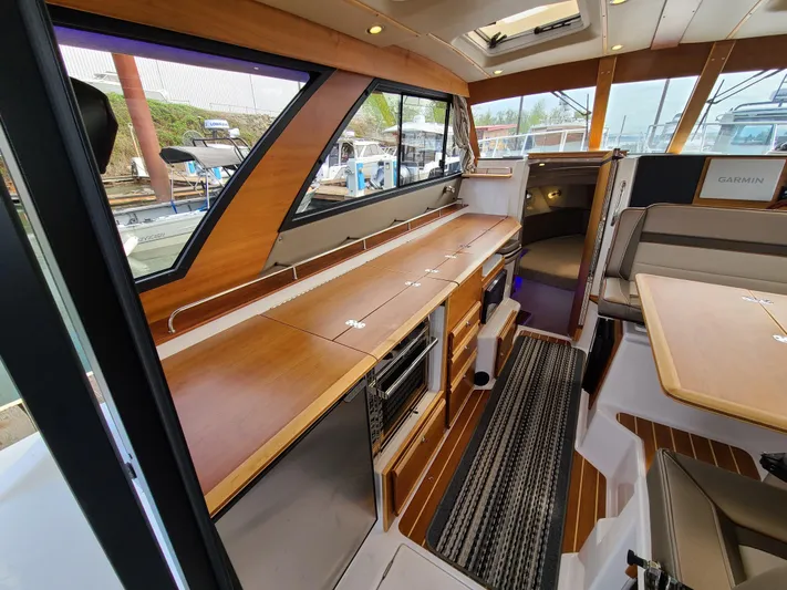  Yacht Photos Pics 2023 Cutwater C-30 Sedan NW Edition interior with modern kitchen and seating area.