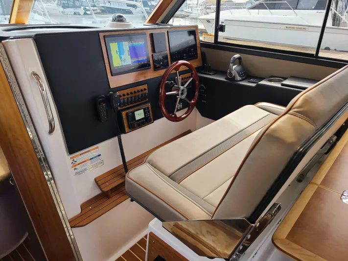  Yacht Photos Pics 2023 Cutwater C-30 Sedan NW Edition helm with navigation screens and steering wheel.