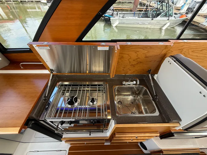  Yacht Photos Pics 2023 Cutwater C-30 Sedan NW Edition boat kitchen with stove and sink.