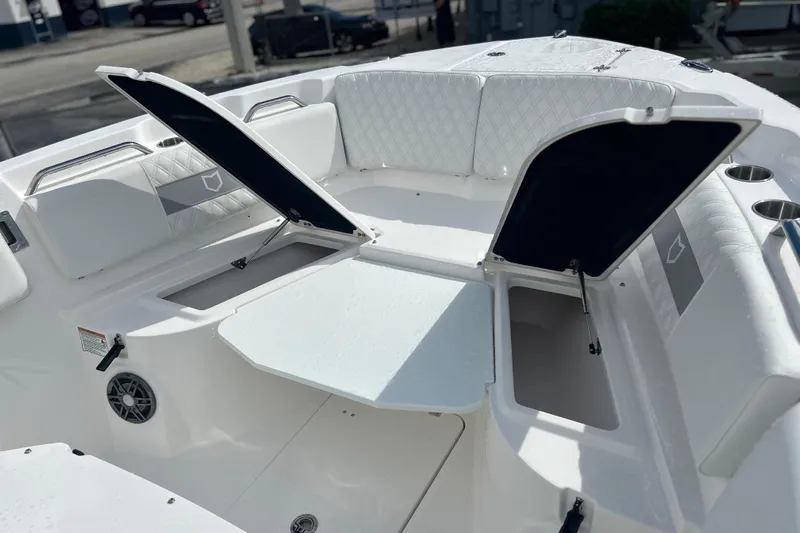  Yacht Photos Pics 2026 Sea Fox 268 Commander boat interior with open storage compartments and cushioned seating.