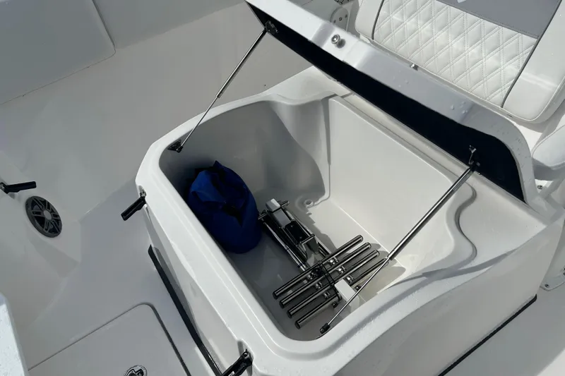  Yacht Photos Pics Storage compartment on 2026 Sea Fox 268 Commander boat, featuring a blue bag and metal accessories.