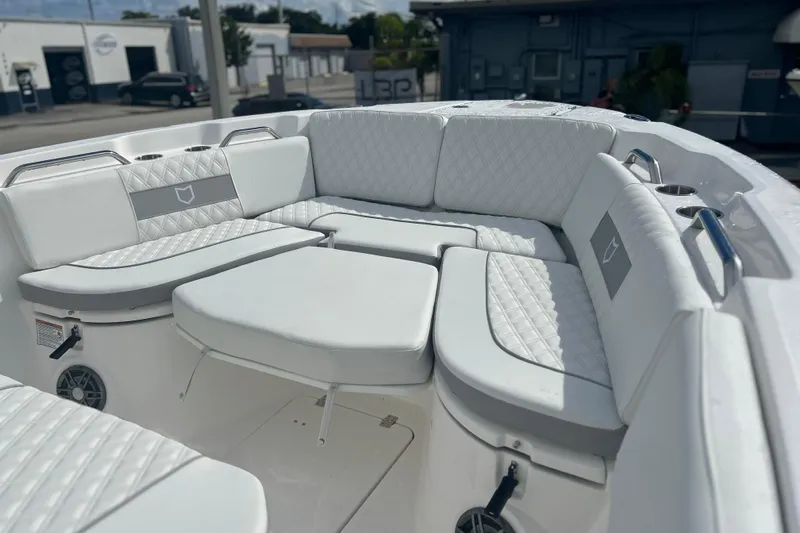  Yacht Photos Pics 2026 Sea Fox 268 Commander boat interior with white cushioned seating and cup holders.