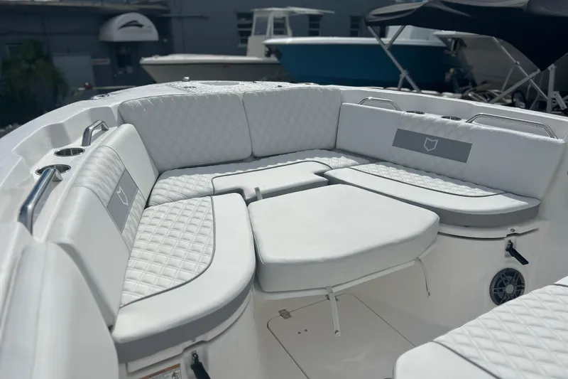  Yacht Photos Pics Luxurious seating area on 2026 Sea Fox 268 Commander boat, featuring quilted white upholstery.