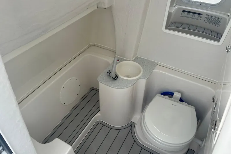  Yacht Photos Pics 2026 Sea Fox 268 Commander boat bathroom with toilet and sink, featuring modern design.