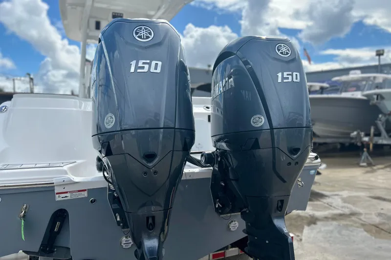  Yacht Photos Pics 2026 Sea Fox 268 Commander with dual Yamaha 150 outboard engines, docked under a cloudy sky.
