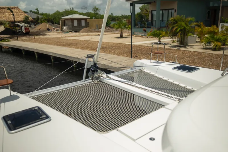 Wanderlust Yacht Photos Pics 2020 Lagoon 40 catamaran docked near tropical waterfront property.
