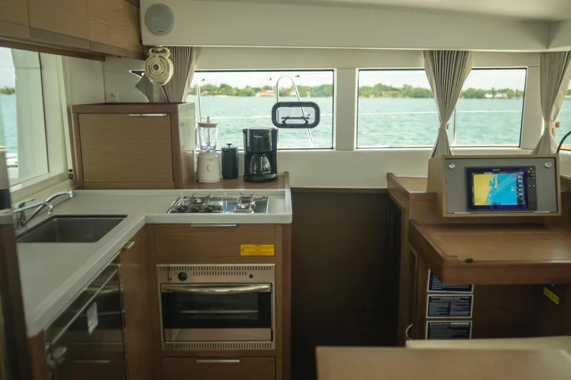 Wanderlust Yacht Photos Pics Interior of 2020 Lagoon 40 catamaran kitchen with modern appliances and navigation system.