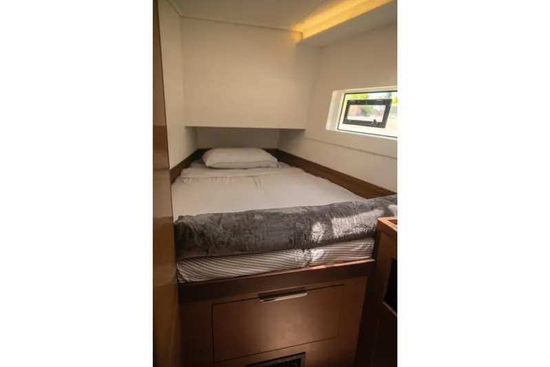 Wanderlust Yacht Photos Pics Cozy cabin interior of 2020 Lagoon 40 catamaran with bed and window.