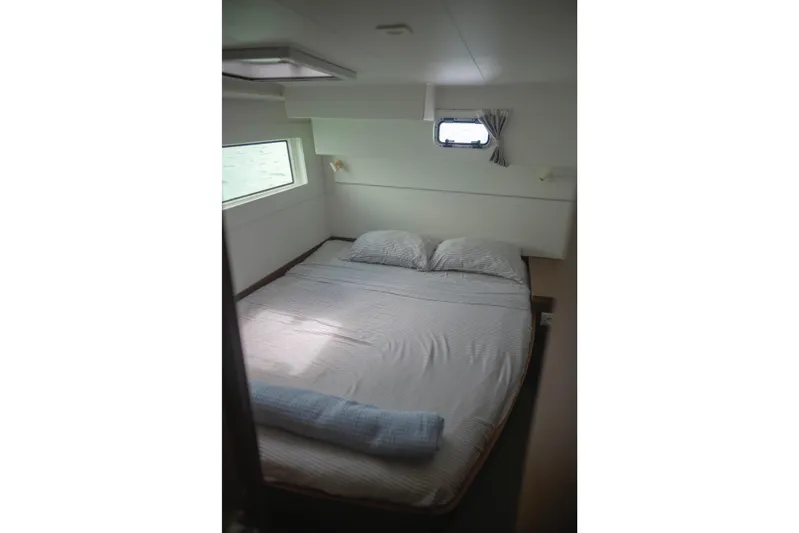 Wanderlust Yacht Photos Pics Cozy bedroom in 2020 Lagoon 40 catamaran with window and soft lighting.
