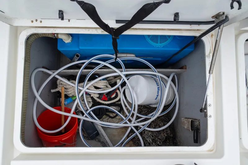 Wanderlust Yacht Photos Pics Storage compartment of 2020 Lagoon 40 boat with ropes, hoses, and equipment.