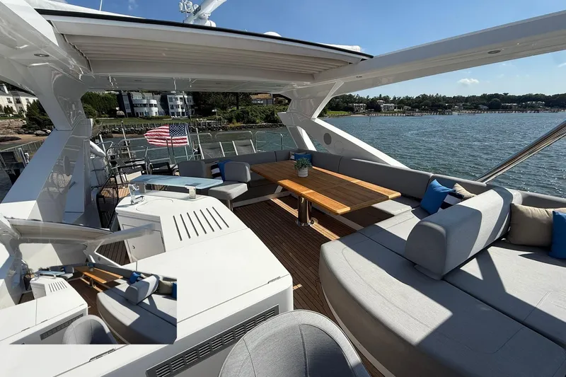  Yacht Photos Pics Luxurious 2021 Sunseeker 76 Yacht with spacious outdoor seating and scenic waterfront view.