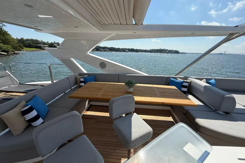  Yacht Photos Pics Luxurious Sunseeker 76 Yacht 2021 with elegant outdoor seating and ocean view.