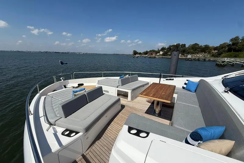  Yacht Photos Pics Luxurious 2021 Sunseeker 76 Yacht deck with elegant seating and scenic ocean view.