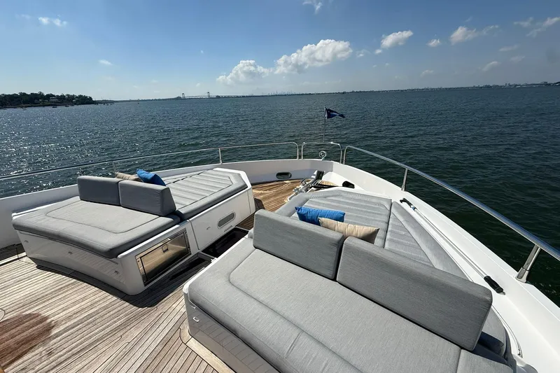  Yacht Photos Pics Luxurious 2021 Sunseeker 76 Yacht deck with plush seating, overlooking serene waters.