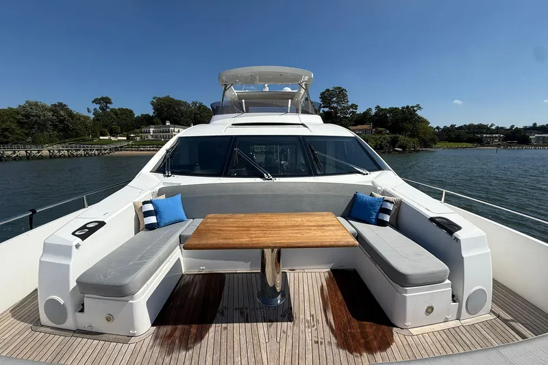  Yacht Photos Pics Luxurious 2021 Sunseeker 76 Yacht with outdoor seating and table on deck.