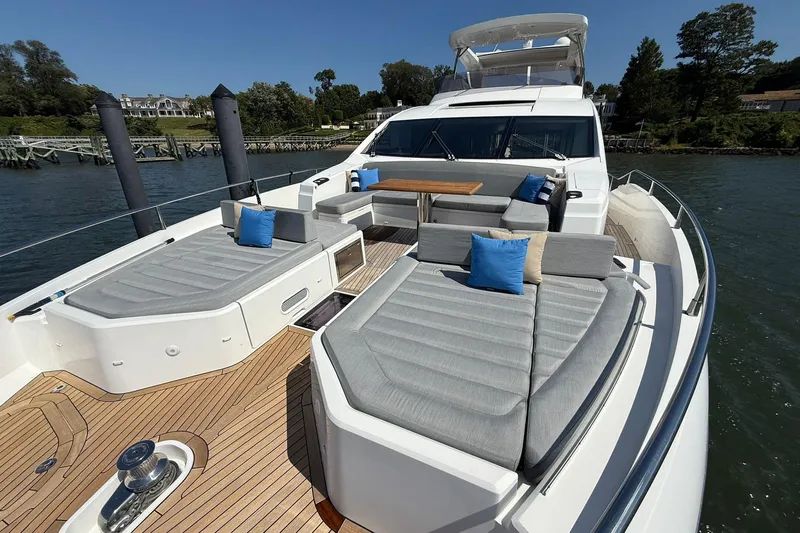  Yacht Photos Pics Luxurious 2021 Sunseeker 76 Yacht with spacious deck, elegant seating, and scenic waterfront view.
