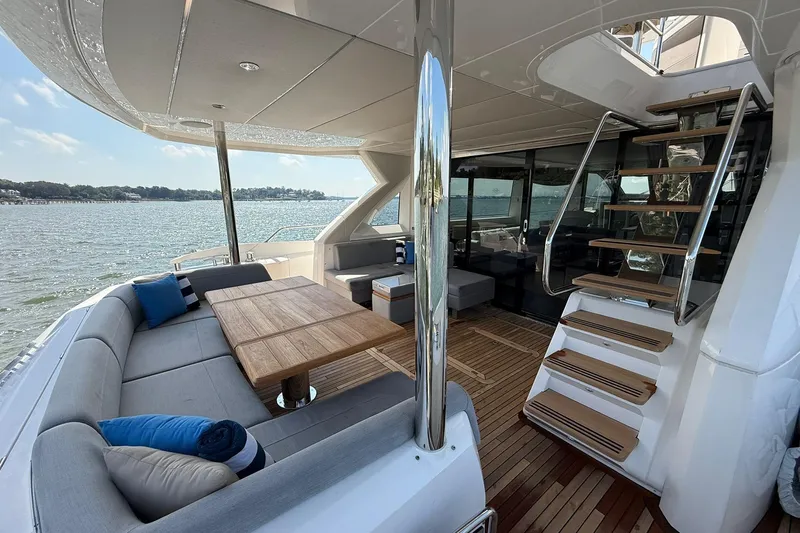  Yacht Photos Pics Luxurious 2021 Sunseeker 76 Yacht with elegant outdoor seating and scenic water views.