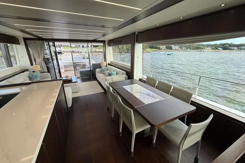  Yacht Photos Pics Luxurious interior of 2021 Sunseeker 76 Yacht with elegant dining area and scenic water views.