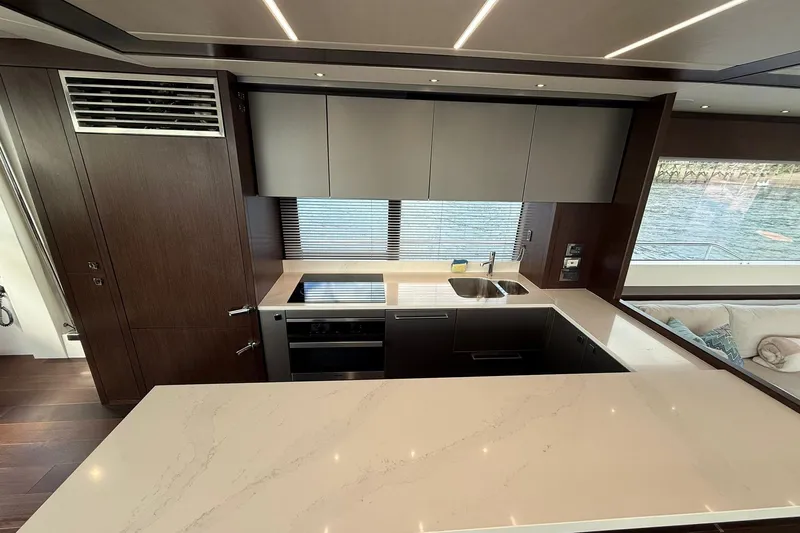  Yacht Photos Pics Luxurious kitchen interior of 2021 Sunseeker 76 Yacht with modern appliances and waterfront view.