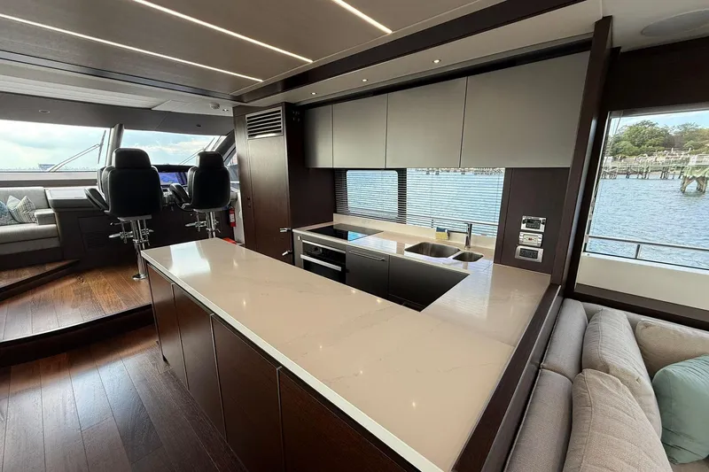  Yacht Photos Pics Luxurious interior of 2021 Sunseeker 76 Yacht with modern kitchen and scenic water view.