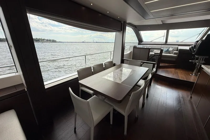  Yacht Photos Pics Luxurious interior of 2021 Sunseeker 76 Yacht with elegant dining area and scenic water views.