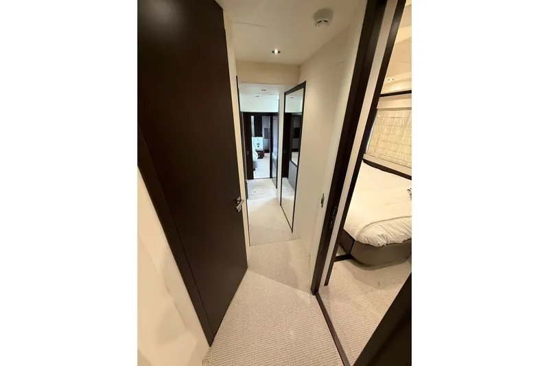  Yacht Photos Pics Hallway inside 2021 Sunseeker 76 Yacht, featuring modern interior design and luxurious bedroom.
